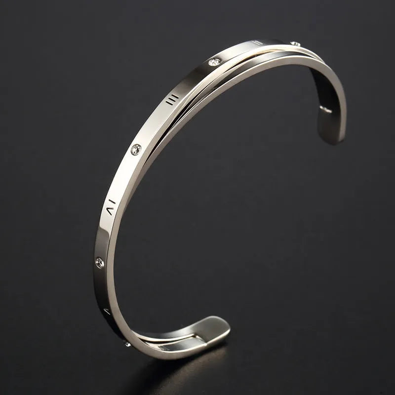 Open-ended stainless steel women's bracelet with zircon stones in rose, gold, or steel colour.
