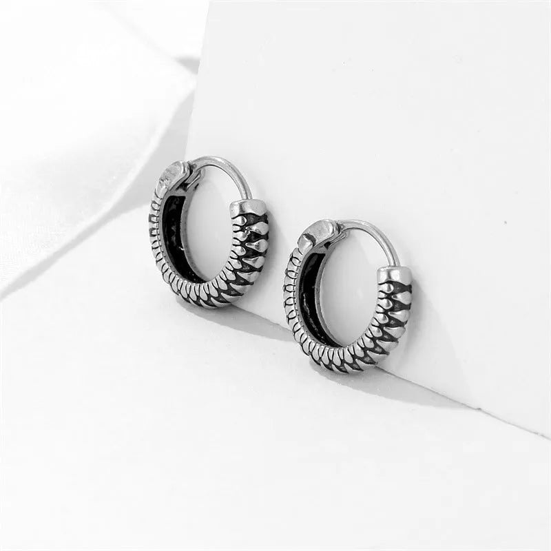 Geometric retro twist stainless steel earrings with circular sports style element in silver