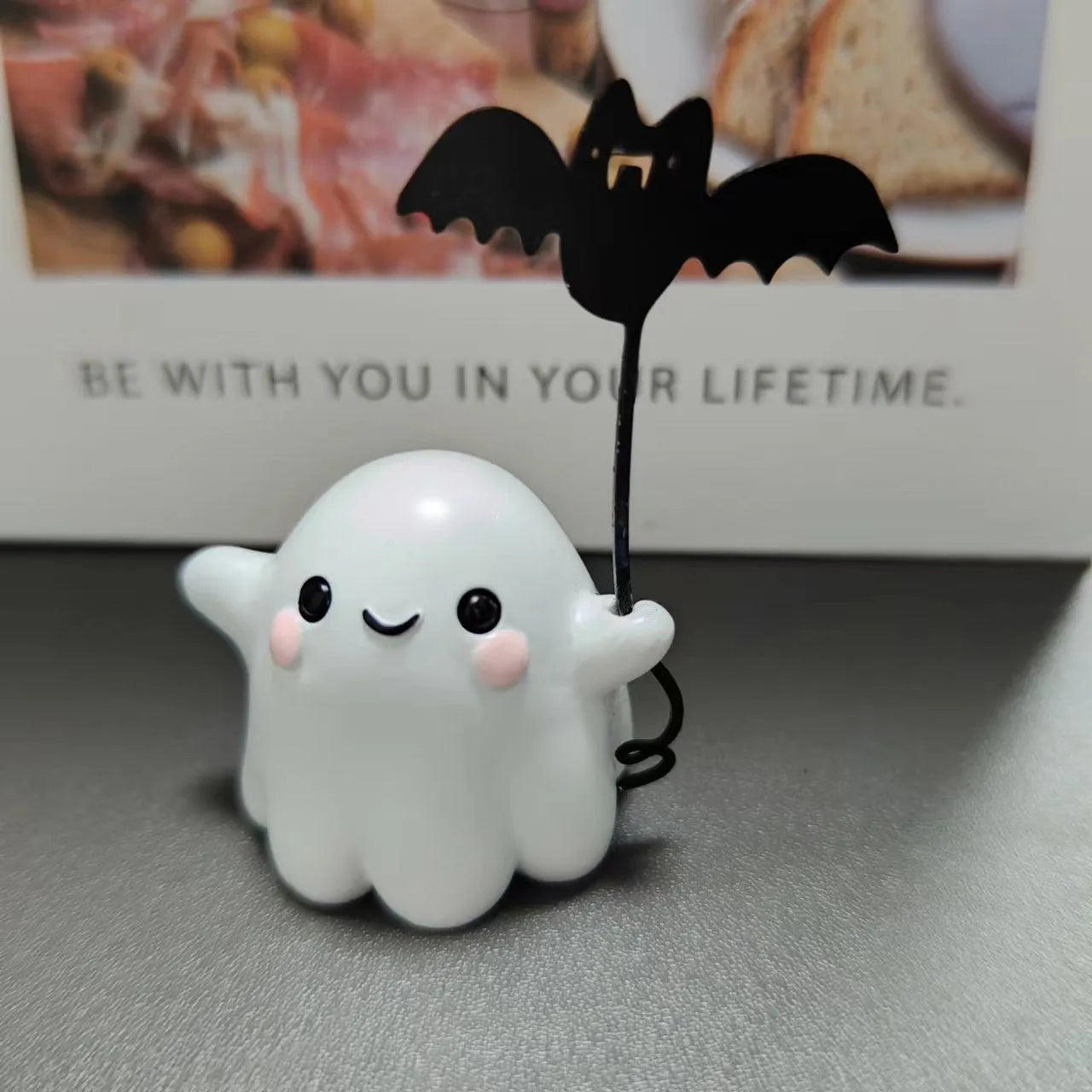Mini resin statue of a white ghost walking a black bat, Halloween decoration