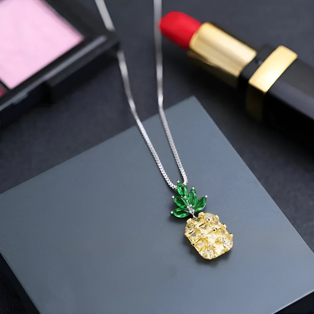 Silver geometric women's necklace with a pineapple and diamond motif pendant.