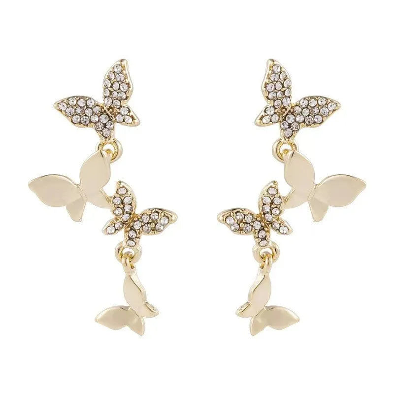 Gold tone butterfly drop earrings with copper construction for women
