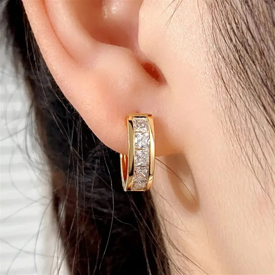 A pair of geometric quadrilateral copper earrings for women in a gold colour finish