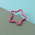 Zinc alloy five-pointed star keychain charm in multiple colour options on a white background.