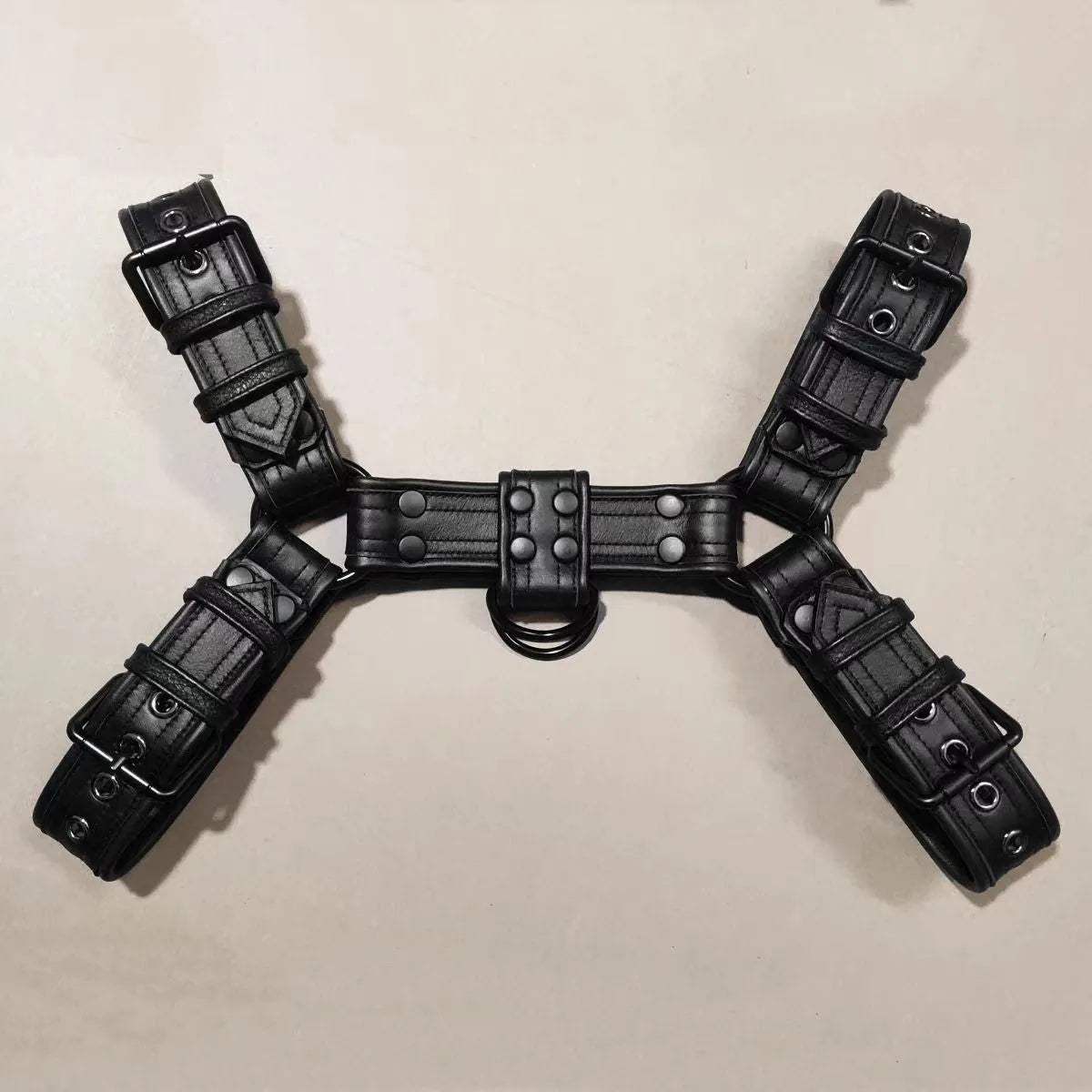Men's black leather chest muscle bondage strap with metal buckles and adjustable shoulder harness design