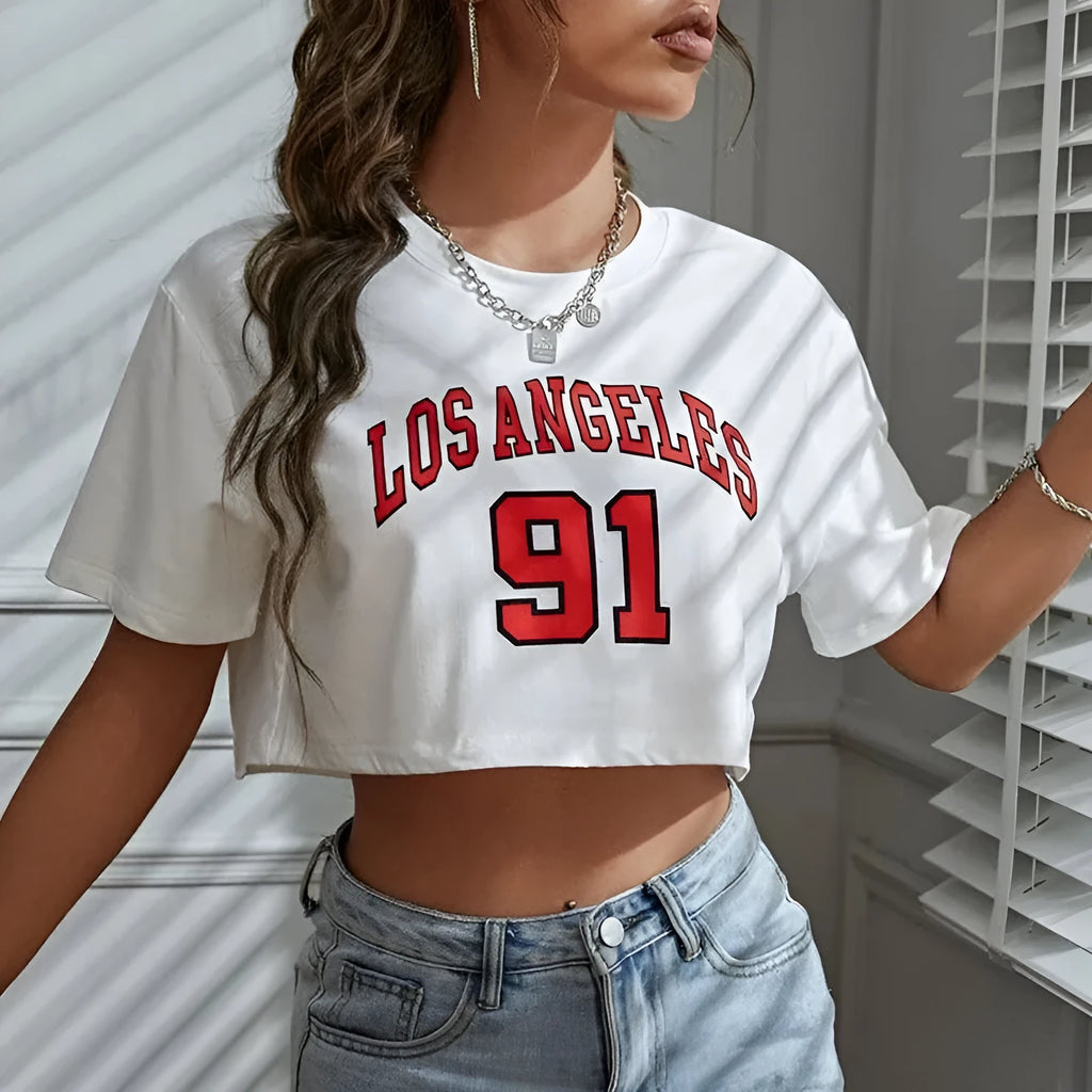 Women's black loose fit cotton T-shirt with exposed navel design and printed white English letters.