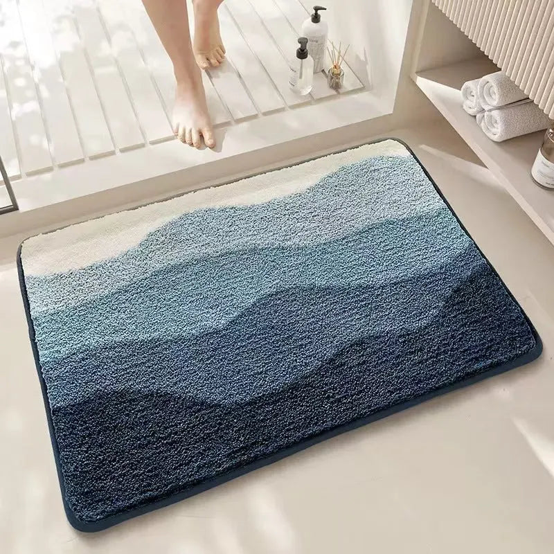 Rainbow pattern floor mat in sky blue and white colours with a flat polyester pile and plastic backing.