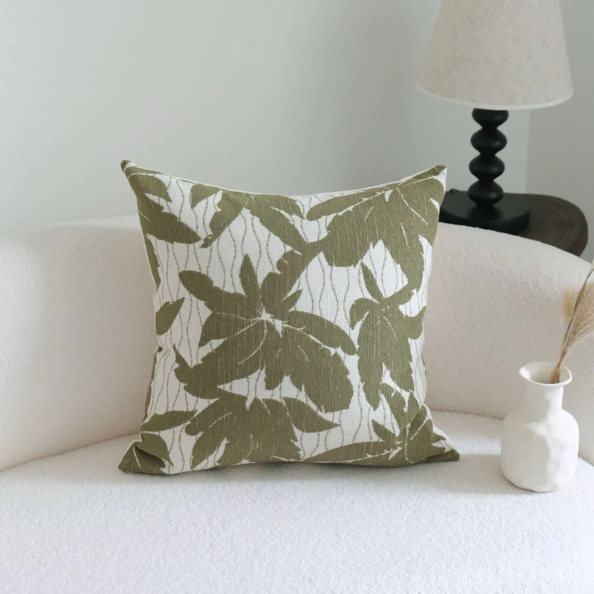 Green cotton and linen hotel sample pillow with tassel or beaded trim, shown in one of three pattern options.