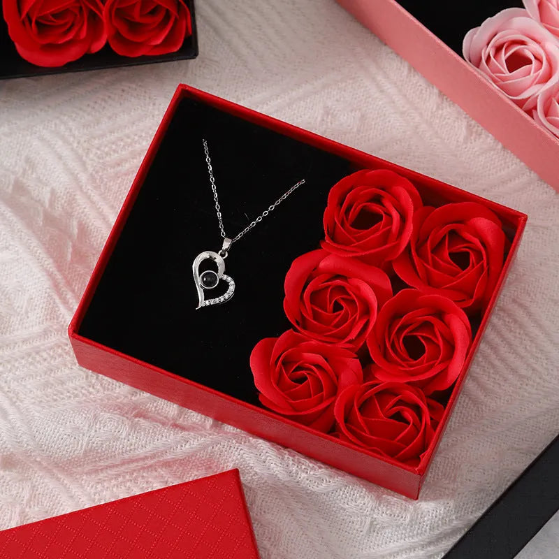 Red Korean-style gift box open to show six sculpted soap roses, with a matching handbag beside it.