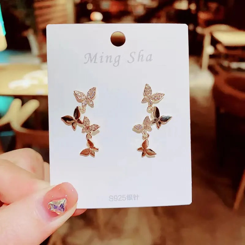 Gold tone butterfly drop earrings with copper construction for women
