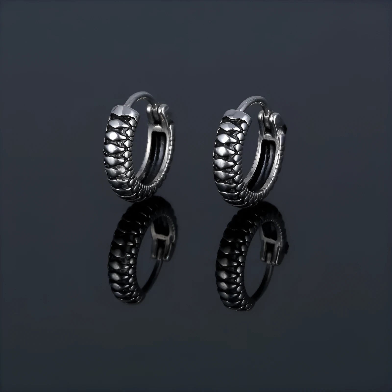 Geometric retro twist stainless steel earrings with circular sports style element in silver