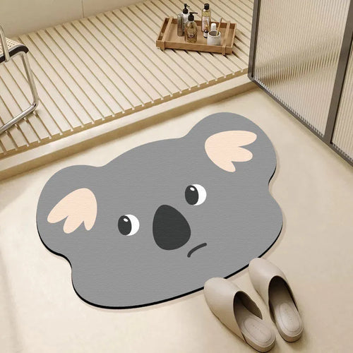 Cartoon animal diatomite absorbent bathroom mat in alien shape on bathroom floor.