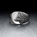 Men's silver alloy ring with a geometric domineering wolf design on a grey background.