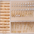 108-piece assortment of gold and yellow alloy stud earrings with geometric shapes and round pearls.