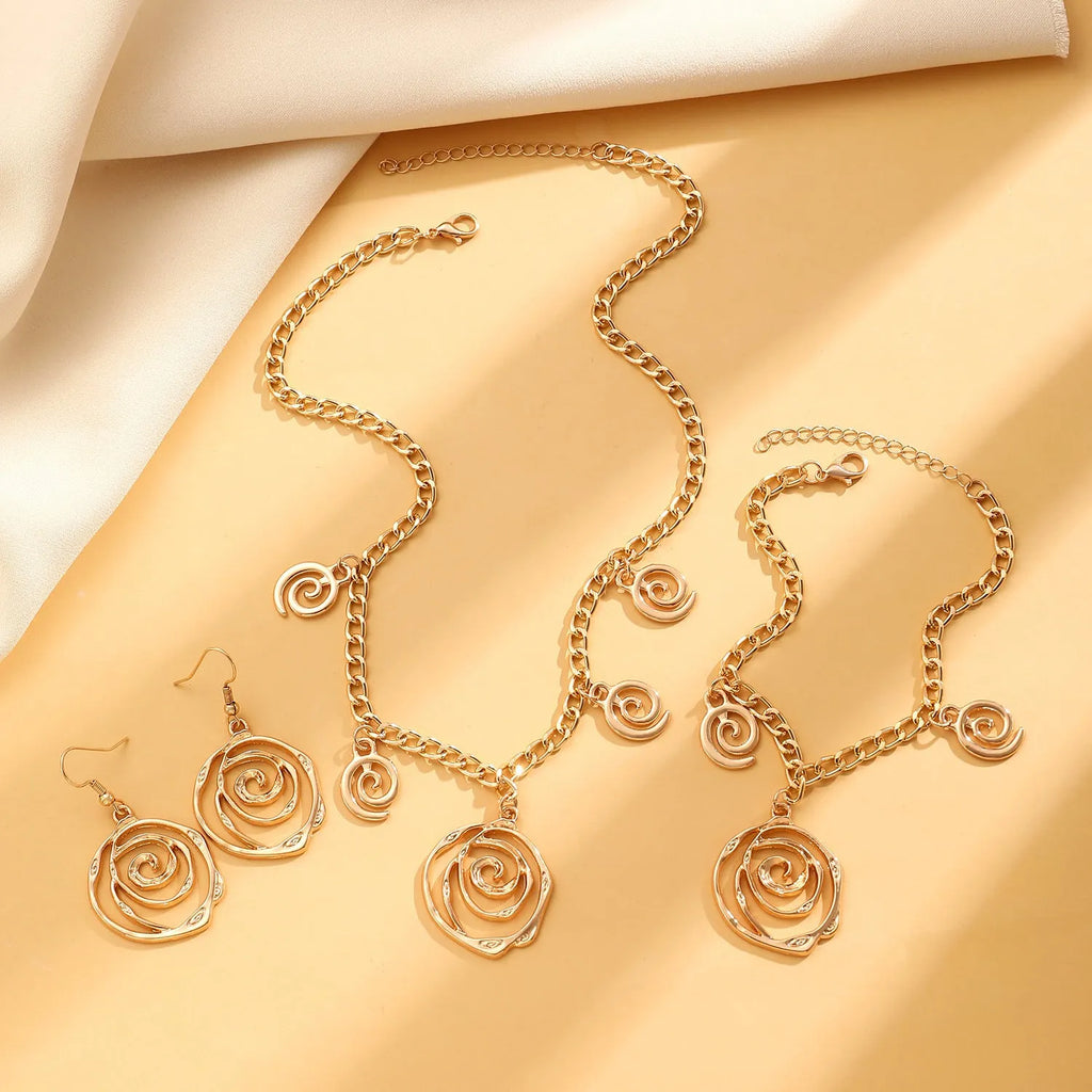Spiral donut geometric jewellery set with necklace, bracelet, and earrings in gold electroplate