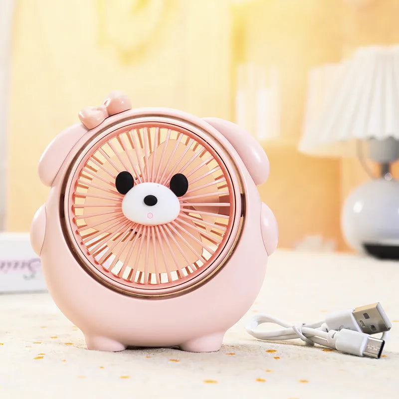 Small plastic desktop fan with a cute dog design, showing USB port and control buttons.