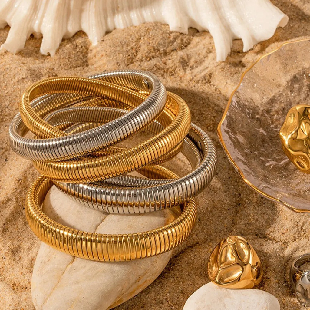 Women's titanium steel elastic bracelet with vertical stripe ring pattern in gold finish