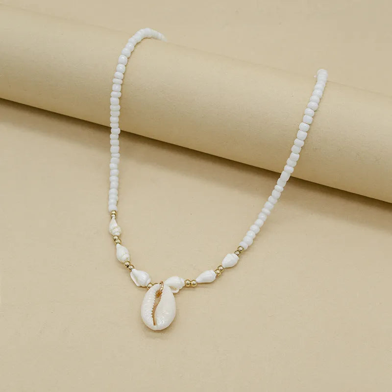 White conch shell necklace with mother-of-pearl pendant on electroplated chain with bead accents