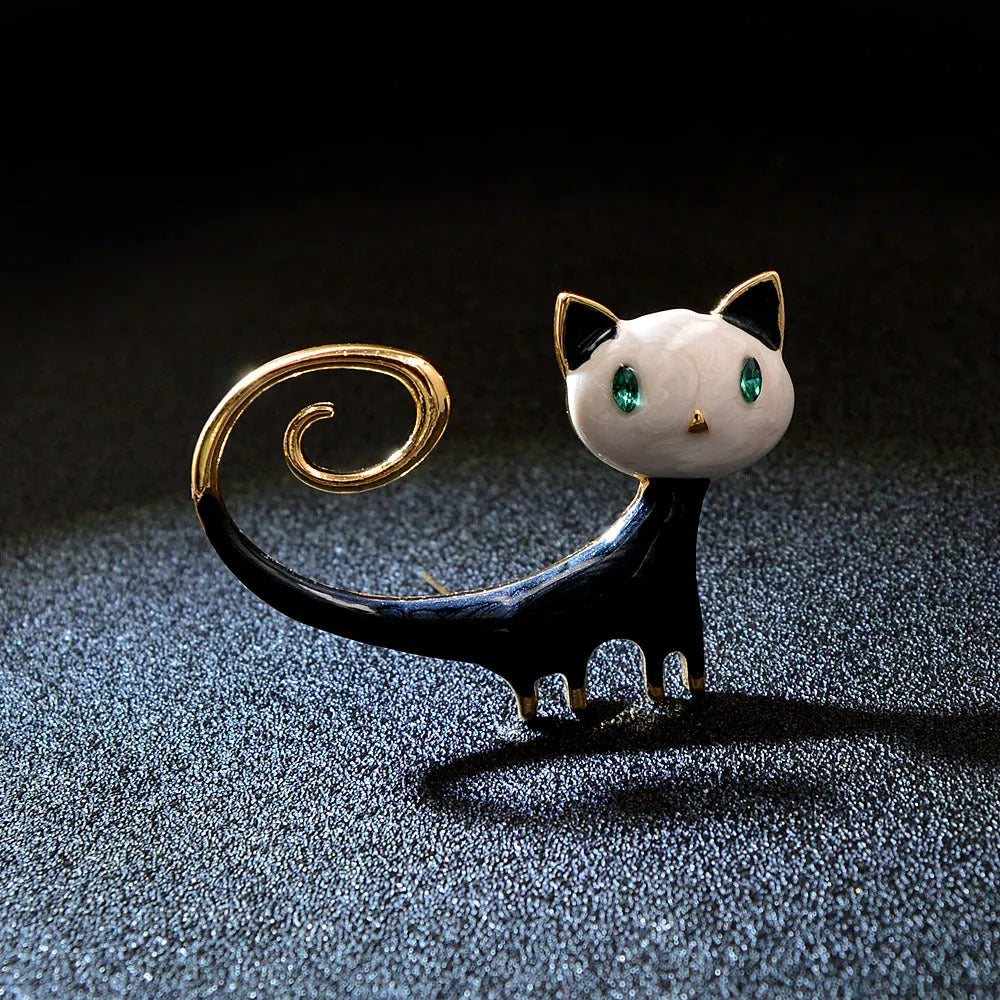 White or orange kitty cat brooch with painted upward tail design on alloy metal