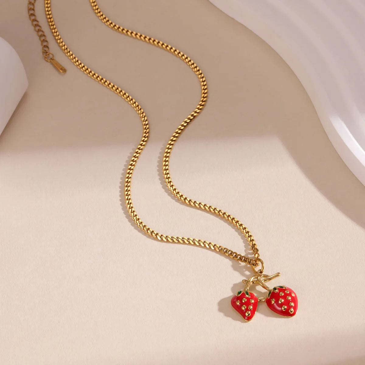 Stainless steel strawberry pendant necklace on an alloy chain in red or white powder gradient.