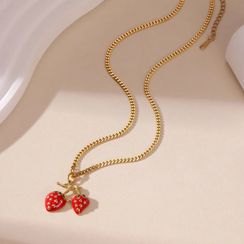 Stainless steel strawberry pendant necklace on an alloy chain in red or white powder gradient.