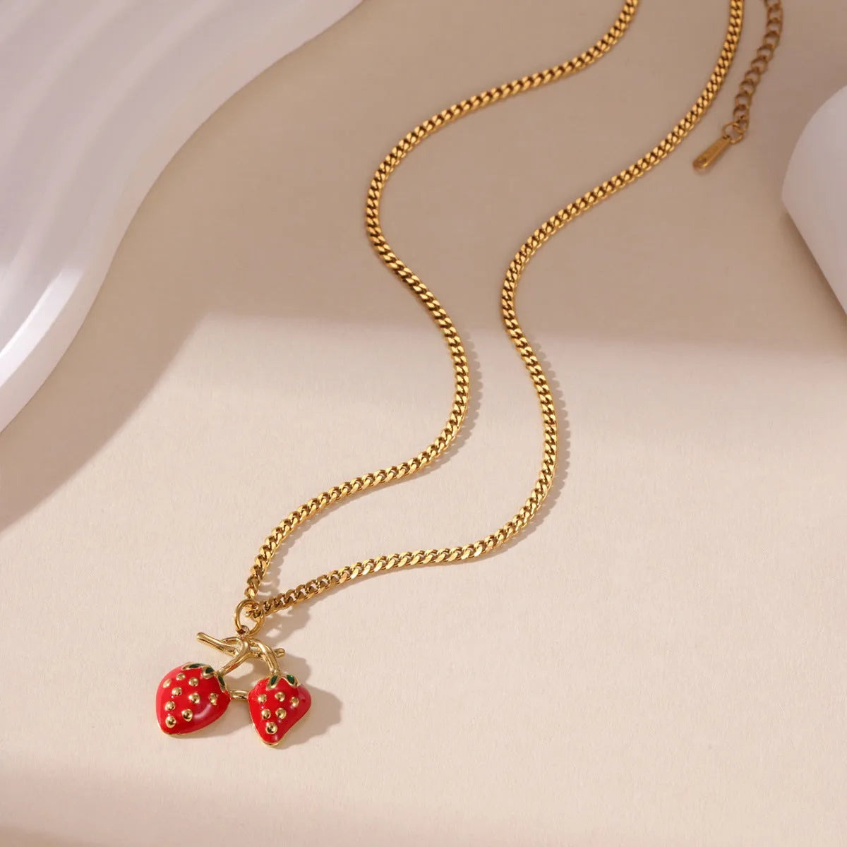 Stainless steel strawberry pendant necklace on an alloy chain in red or white powder gradient.