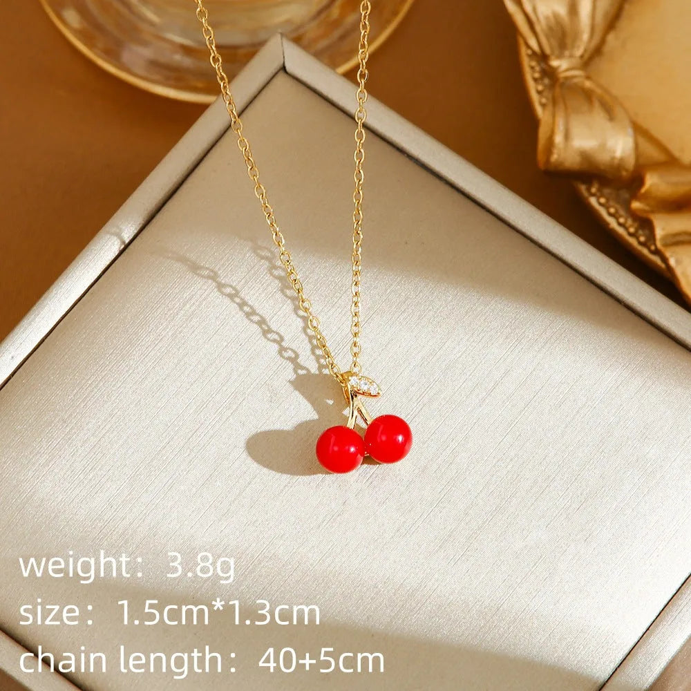 Delicate indie charm necklace with cherry, strawberry, and pepper pendants on a titanium steel chain.