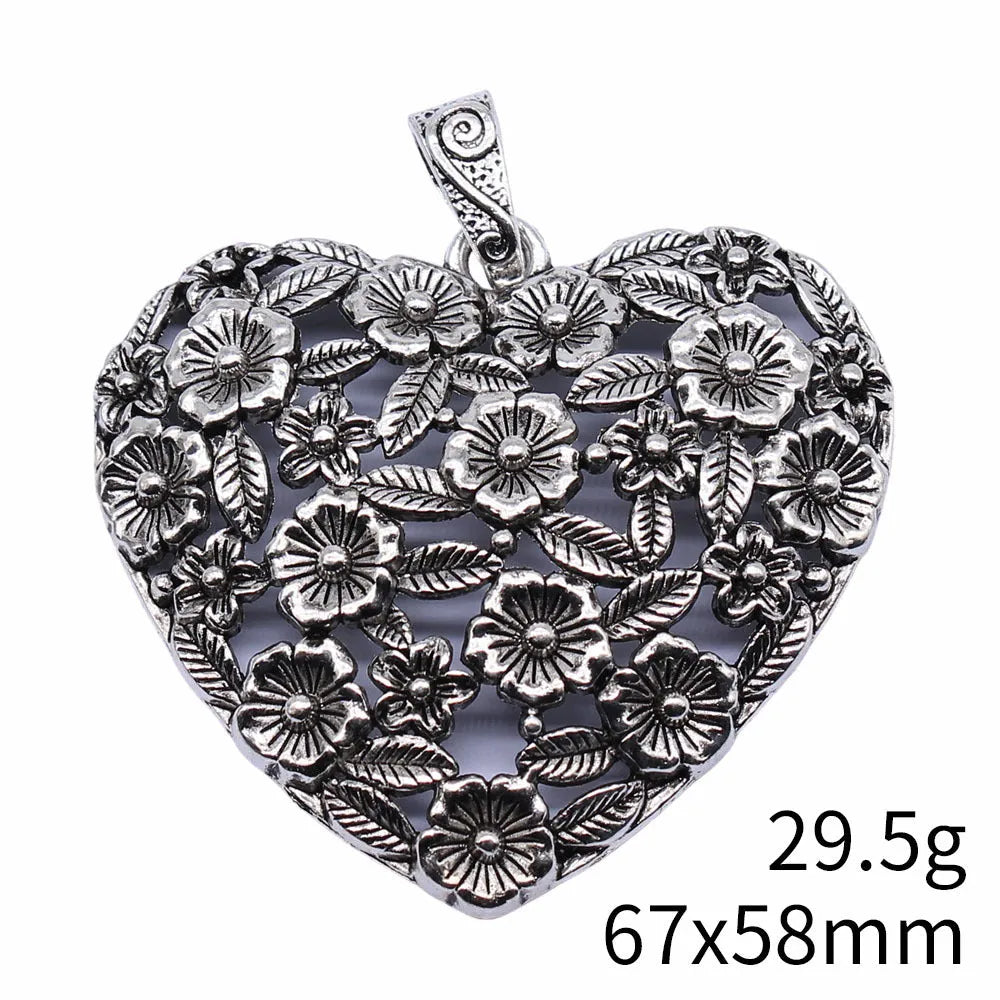 Ancient silver hollow flower love symbol alloy pendant on a dark background.