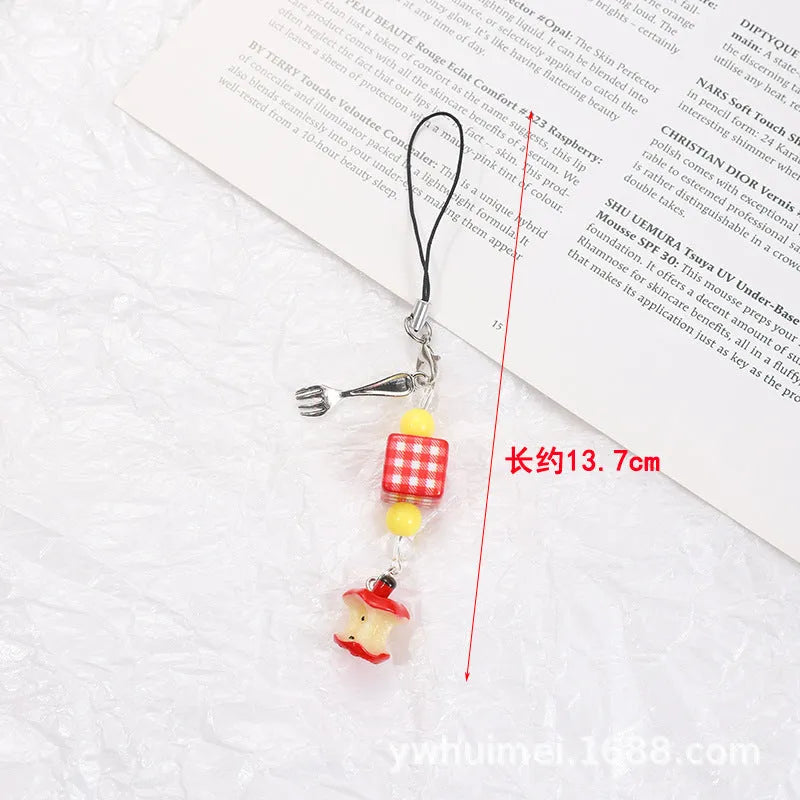 Fruit-themed mobile phone charm keychain with apple and strawberry designs in plastic/resin construction