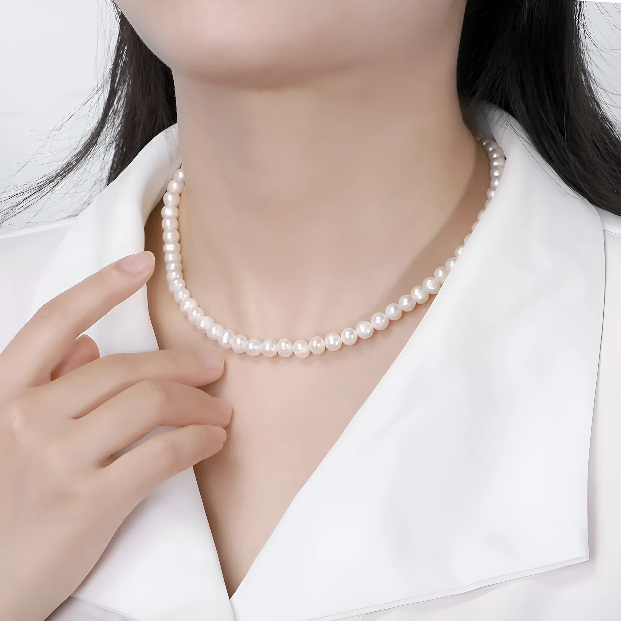 Women's silver necklace with a single round freshwater pearl and adjustable lobster clasp.