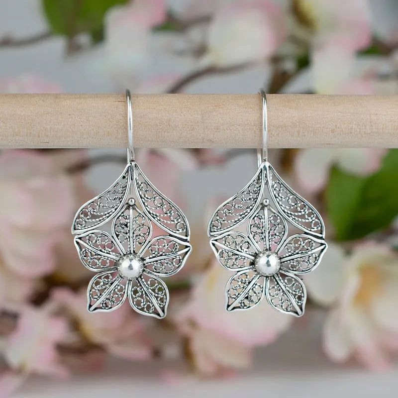 Silver alloy hollow flower leaf-shaped women's earrings with retro floral metal design