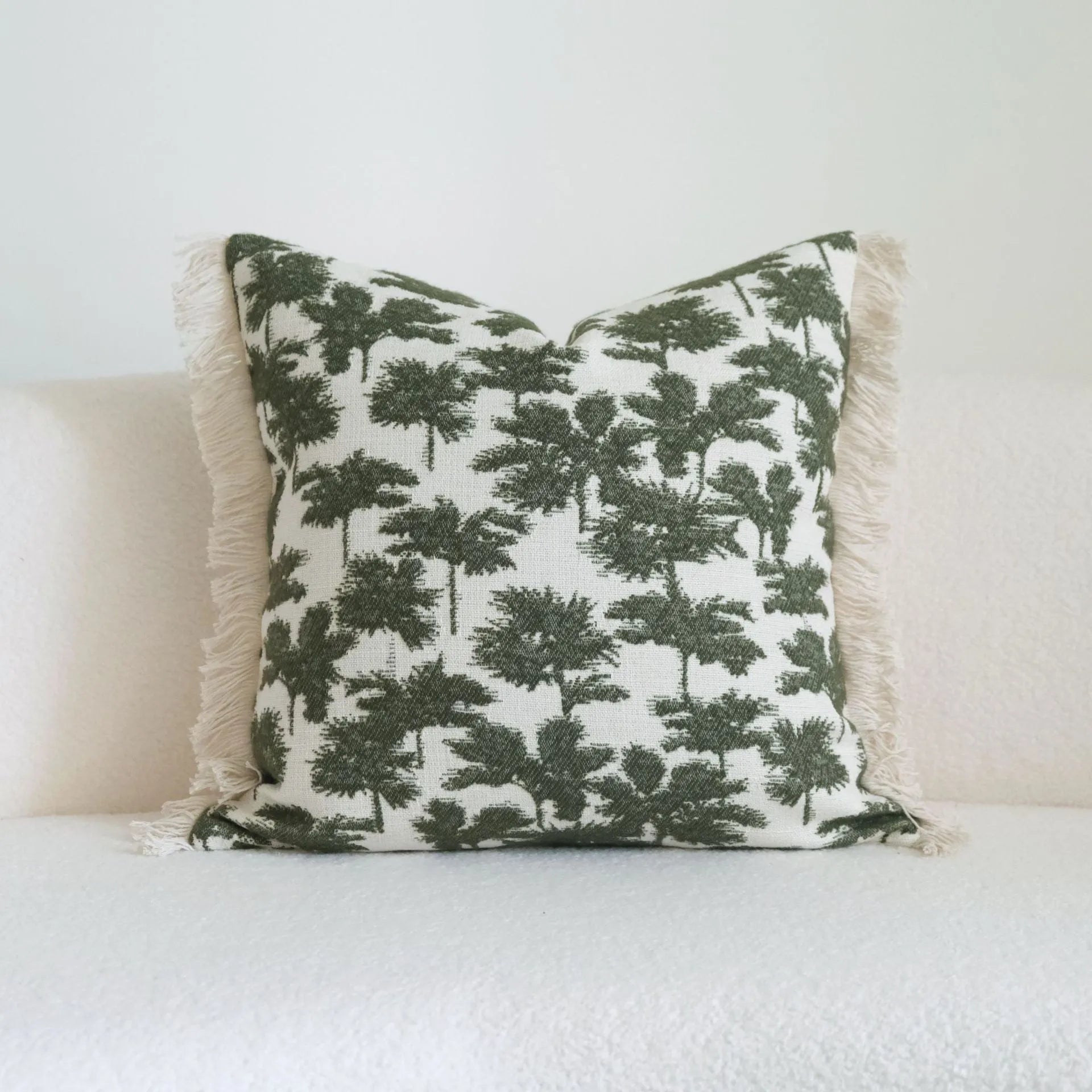 Green cotton and linen hotel sample pillow with tassel or beaded trim, shown in one of three pattern options.