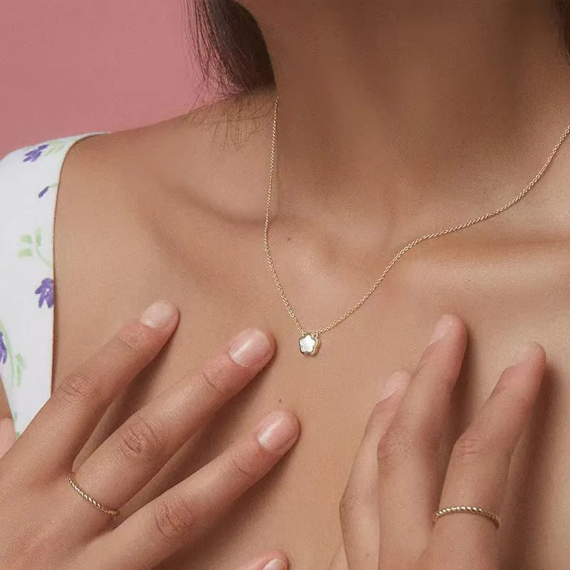 White mother-of-pearl flower necklace with floral pendant on chain