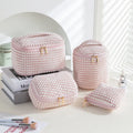 Four cube-shaped flannelette makeup bags in different colours: pink, khaki, pink dots, and blue with dots.