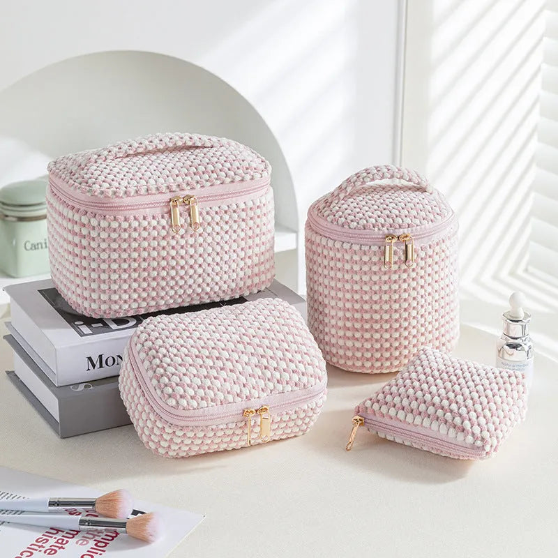 Set of four cube-shaped flannelette makeup bags in blue with white dots pattern.
