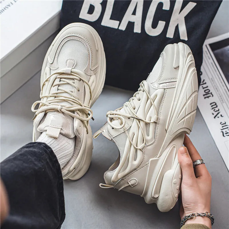 Men's low-top sneakers in beige with mesh upper, rubber sole, and front lace-up design on a white background.