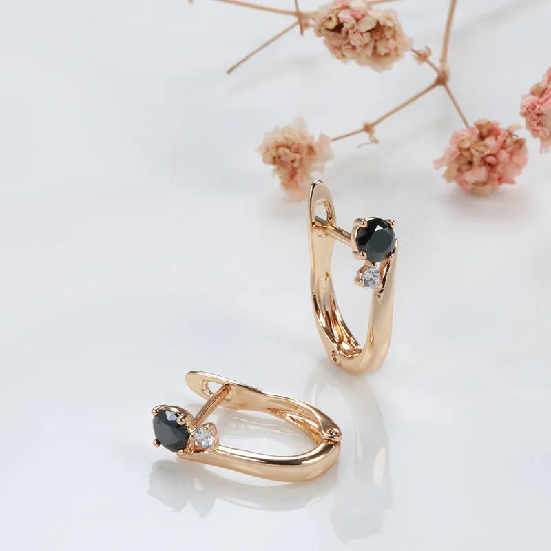 Gold-coloured drop earrings with geometric black agate design and retro styling