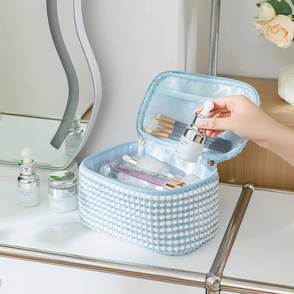 Four cube-style flannelette makeup bags in a set, shown in a blue with dots colour theme.