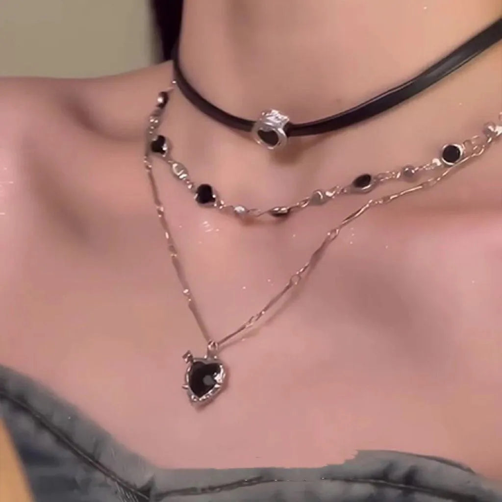 Women's twin necklace set with leather heart pendants on an adjustable alloy clavicle chain.