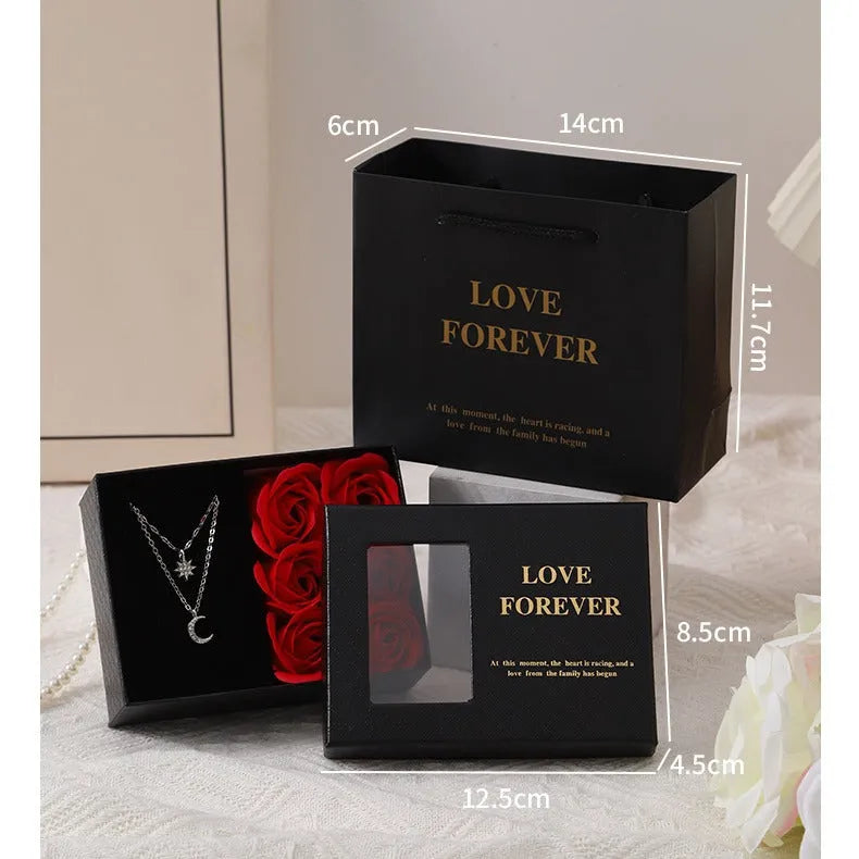 Red Korean-style gift box open to show six sculpted soap roses, with a matching handbag beside it.