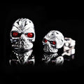 Retro skull stud earrings with red eye detailing on alloy metal with electroplated finish