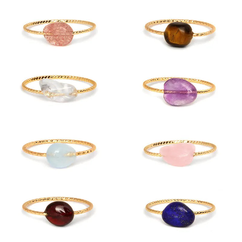 Original geometric design women's ring in coloured agate stone on a plain background.