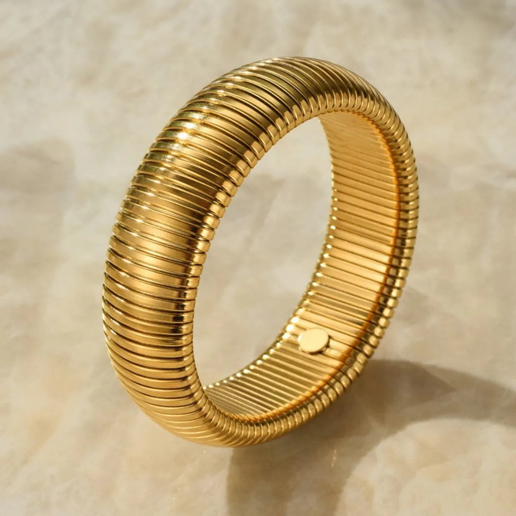 Women's titanium steel elastic bracelet with vertical stripe ring pattern in gold finish