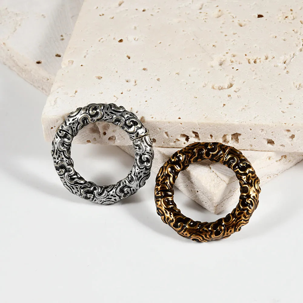 A pair of fashion earrings with a raised totem pattern, made from stainless steel in one of 15 available colour finishes.