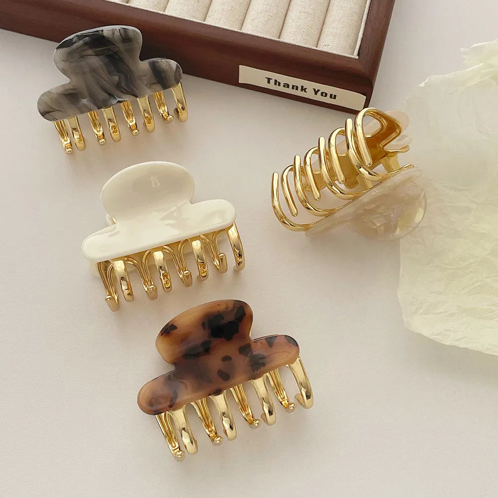 Women's hair barrettes with metal grip in alloy acrylic showing four colour options
