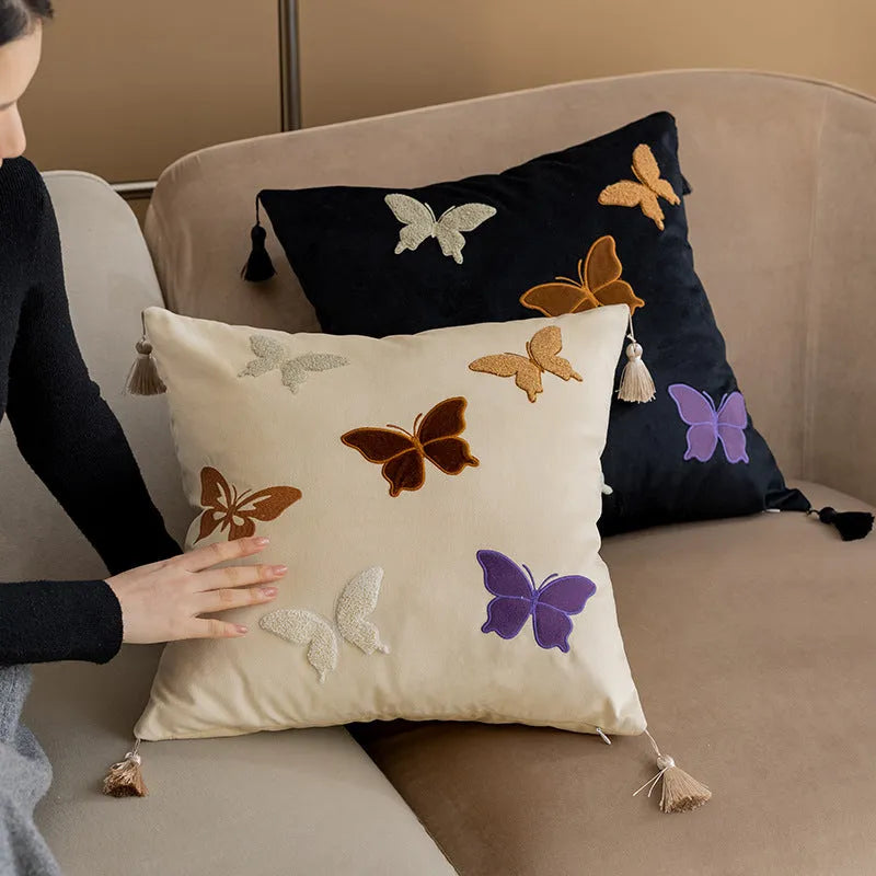 Square beige cushion with colourful embroidered butterfly and Chinese floral pattern.