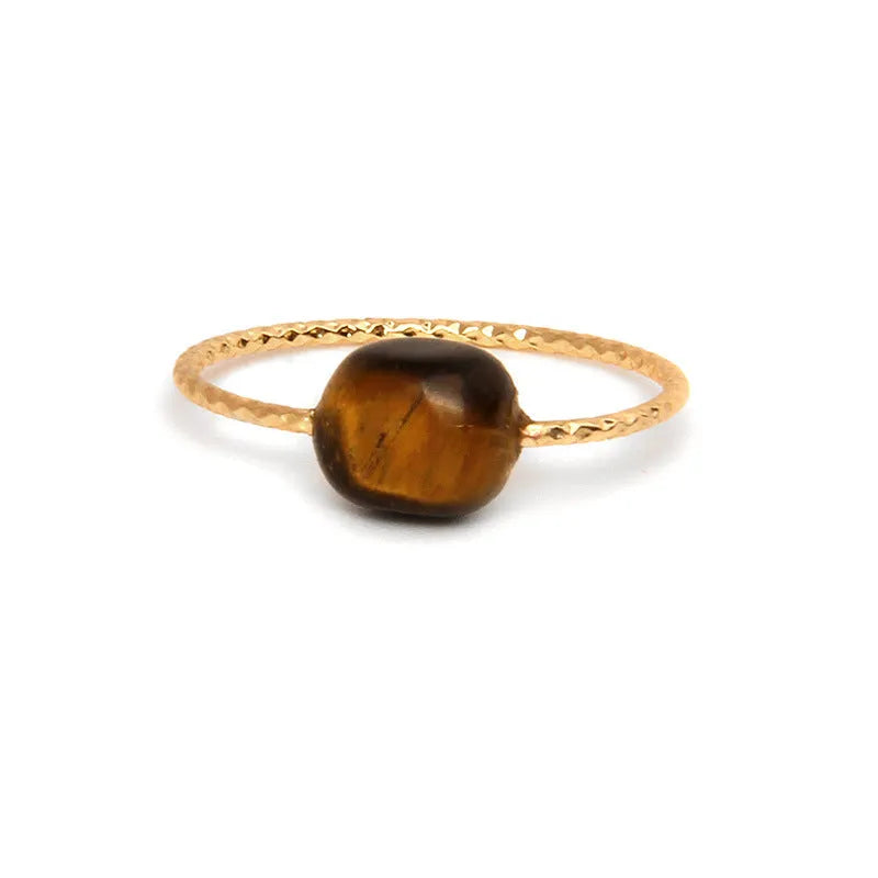 Original geometric design women's ring in coloured agate stone on a plain background.