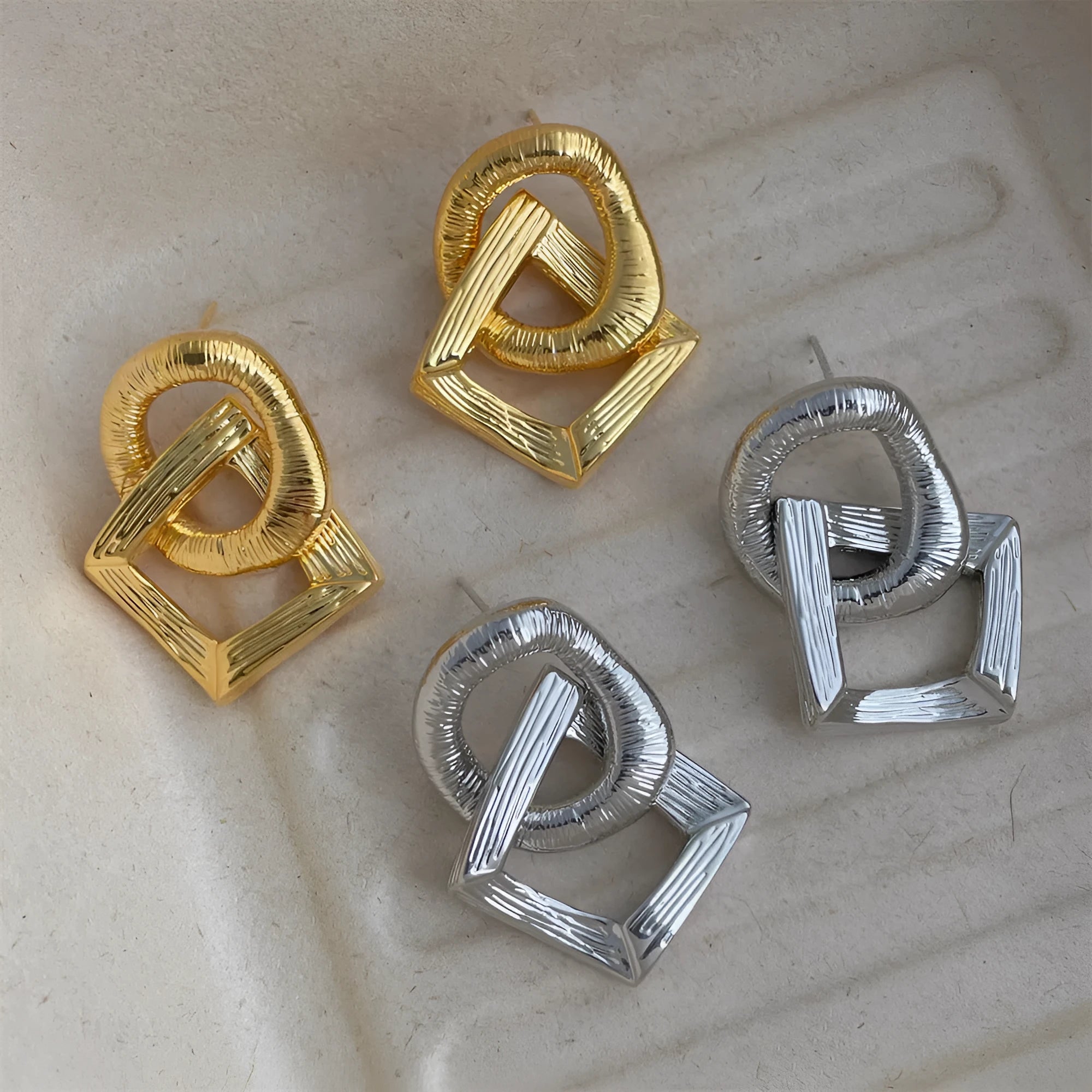 Geometric circle pendant earrings with retro styling in gold or silver electroplated colours measuring 3.4cm height