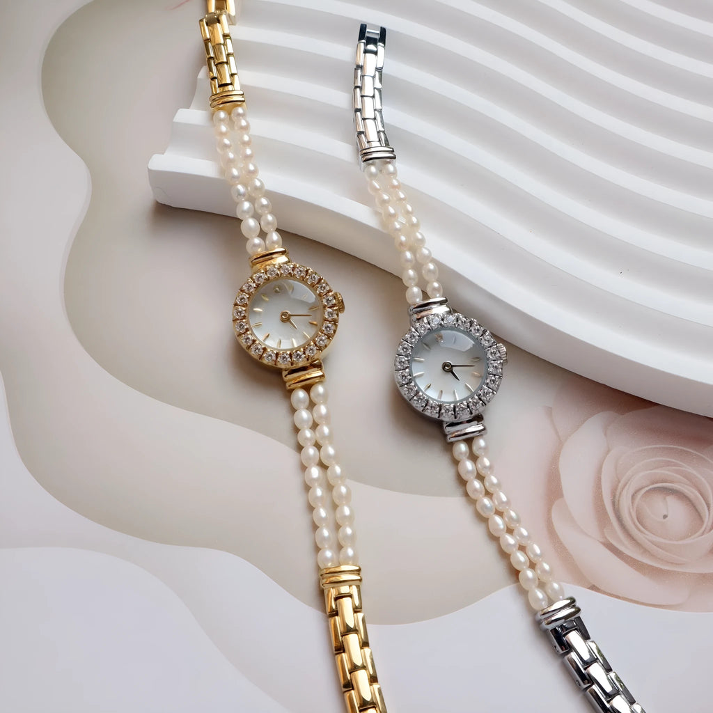 Light gold women's bracelet watch with freshwater pearls and an 18mm round dial on a stainless steel strap.