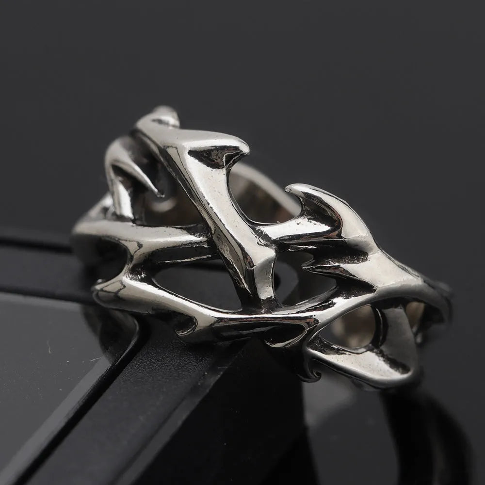 Copper men's ring with geometric thorn and flower design and adjustable band.
