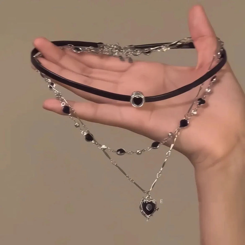 Women's twin necklace set with leather heart pendants on an adjustable alloy clavicle chain.